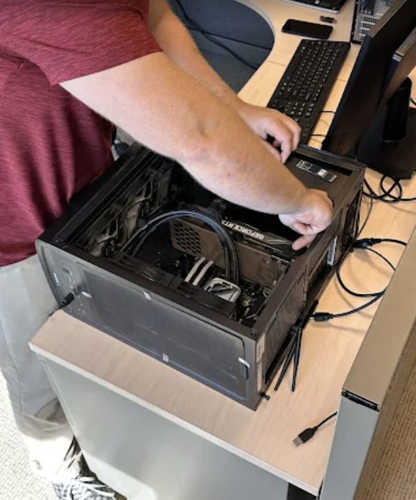 Epoch IT technician repairing desktop computer on-site